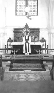Madras, Arcot, South India. Rev. Dorairaj Peter in front of the Altar, Broadway Church. (Used i