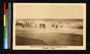 People playing in the ocean surf, Benin, ca.1920-1940