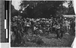 Large group of people standing in a field, Borneo, ca. 1920-1940