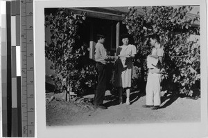 Boys delivering newspaper to a woman at the Granada Japanese Relocation Camp, Amache, Colorado, ca. 1942