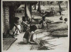 Malabar. Tya women making mats from palm leaves