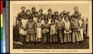 Young orphans standing with a missionary sister, Canada, ca.1920-1940