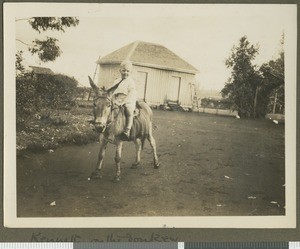 Kenneth Irvine riding a donkey, Chogoria, Kenya, ca.1930