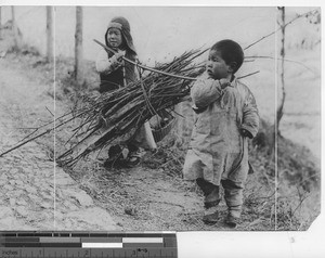 Two small boys carrying sticks at Nanjing, China, 1936