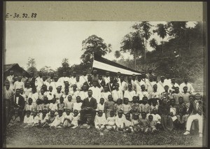 Pastor Isaac Mukonge, who was ordained on 4th August 1917 to serve the Basel Mission congregation in Victoria. He sits surrounded by the members of the christian singing societies of the congregations in Bota and Victoria