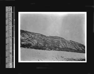 Distant view of cave homes dug into mountain side, Gansu Province, China, ca.1926