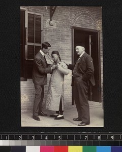 Medical missionaries examining patient, Foshan, China, ca. 1915