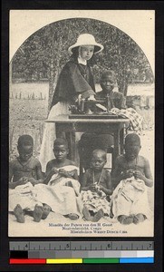 Missionary sister standing with seamstresses, Congo, ca.1920-1940