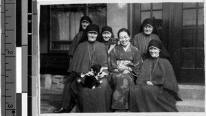 Maryknoll Sisters sitting in front of the entrance to Maryknoll Fathers' house, Karasaki, Japan, March 13, 1938