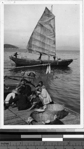 Family meal on the dock, Loting, China, ca. 1935