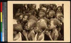 Children gathered with their hands clasped in prayer, Congo, ca.1920-1940