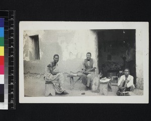 Cobbler mending shoes, Ghana, 1926