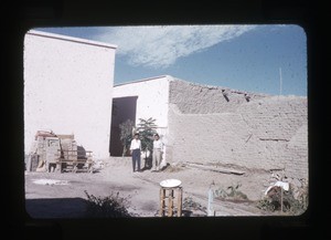 Two men outside a building under construction