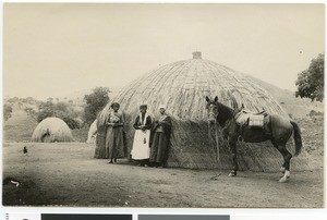 Three African women and a horse in front of a hut, South Africa, 1926
