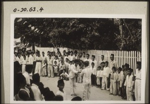 Phases of the mock-battle on the street which takes place before the bridegroom is allowed to go up into the house. Two boys wrestling