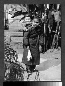 Young woman with happy baby, Sichuan, China, ca.1900-1920