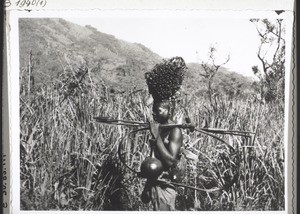 Mbembe man with a bunch of palm nuts