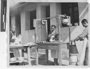 Men cooking outdoors in Guilin, China, 1947