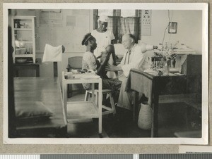 Dr Irvine examines an infant, Chogoria, Kenya, ca.1949