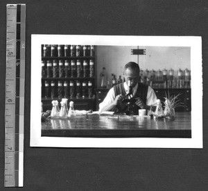 Dr. Li using microscope, Fukien Christian University, Fuzhou, Fujian, China, 1948