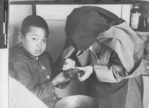 Sister M. Paula at dispensary at Fushun, China, 1936