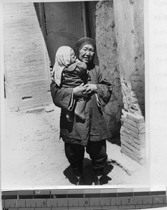 Moslem woman and child with head coverings, Gansu, China, 1936