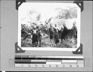 A group of people in front of a hut, Masukulu, Tanzania, 1936