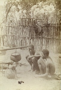 Two kitchen boys taking tobacco, in Leshoma, Northern Rhodesia, Zambia