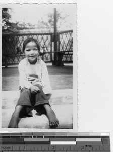 An orphan girl at the orphanage at Luoding, China, 1935