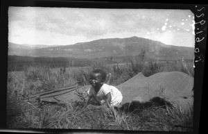 African child sitting on a mat, Graskop, South Africa