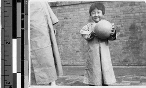 Young girl plays with a ball, Fushun, China, September 1933