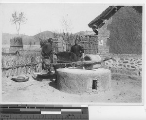 Grinding grain at Fushun, China, 1934