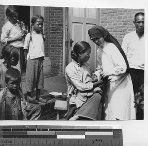 Maryknoll Sister gives medical attention at Fushun, China, 1934