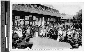 Group of people standing in a circle outside a building, Japan, ca. 1920-1940