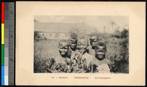 Four young schoolchildren holding flowers, Kwango, Congo, ca.1920-1940