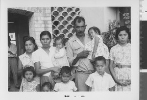 Family in front of building