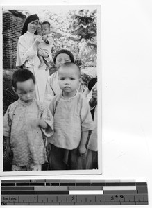 Sr. Monica Marie with orphans at Luoding, China, 1938