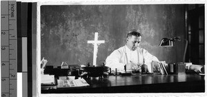 Archbishop Delle Piane working at a desk, Belgian Congo, Africa, ca. 1920-1940