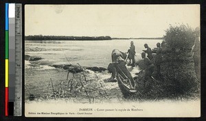 Men pull a canoe to shore, Zambia, ca.1920-1940