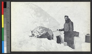 Catholic missionary father standing outside of an igloo, Canada, ca.1920-1940