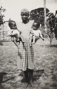 Young woman holding twins, Nigeria, ca. 1925