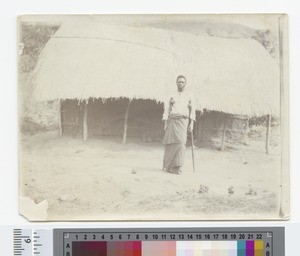 Man standing outside hut, Malawi, ca.1920