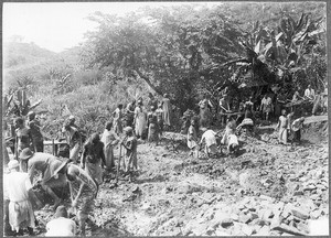 People treading soil to produce loam, Tanzania, ca. 1900-1914