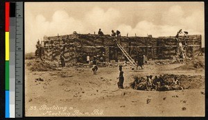 Men laboring to build a mud-brick structure, Angola, ca.1920-1940