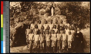 School children gathered before a statue of the Virgin Mary, Congo, ca.1920-1940