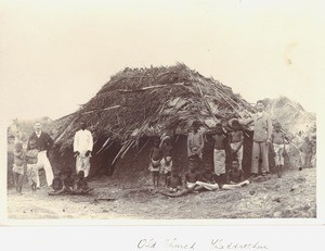 Missionaries with group outside village church, ca. 1900