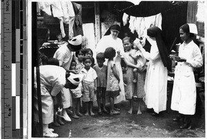 Maryknoll Sisters Eleanor and Frederica doing social service work in the Walled City, Manila, Philippines, 1938