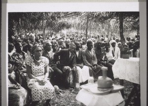 A so-called mission festival in Victoria: a meeting of all the christian congregations of the area around the station in Victoria. The festive meeting-house is a roof of palm leaves