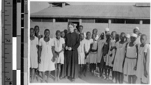 Father Glynn with a group of people, Kisumu, Kenya, Africa, August 1947