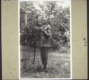 A heathen man, who has just joined an Isango society, with symbols he has been given